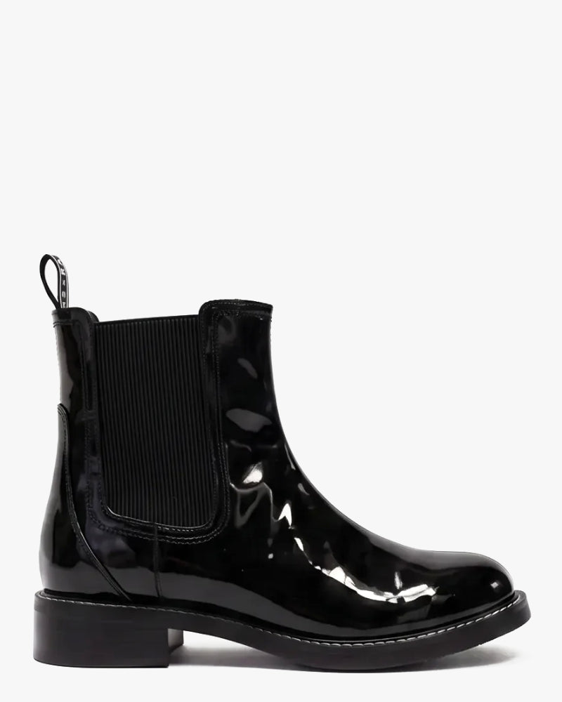A single black patent leather Chelsea boot with a black elastic side gore and pull tab, shown from a side profile against a plain white background.