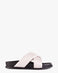 A minimalist slide sandal featuring wide, crisscrossing straps set on a black platform sole, shown against a plain white background.