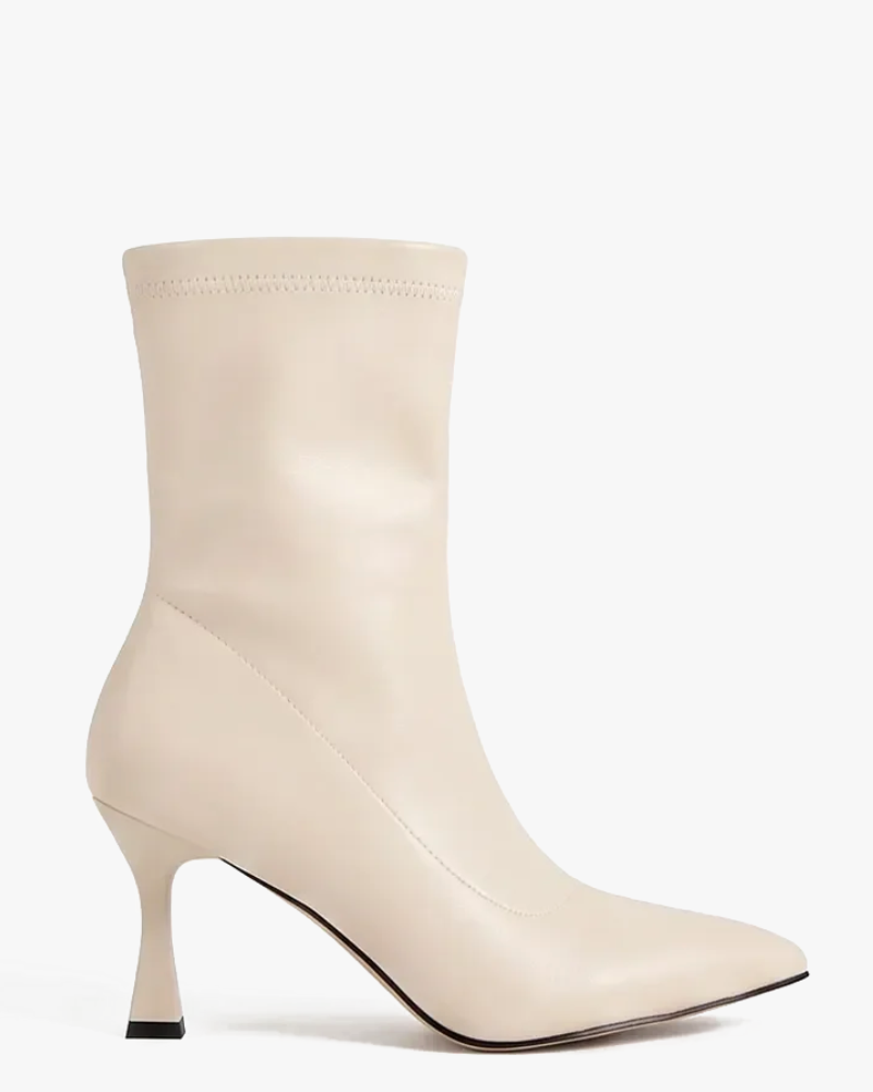 A light beige leather ankle boot with a pointed toe and a slim kitten heel, shown against a plain white background.