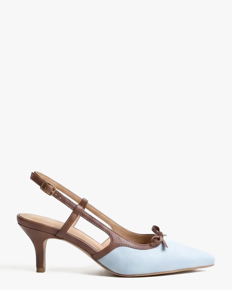 A light blue suede pointed-toe slingback pump with brown leather straps, a low kitten heel, and a small bow detail on the vamp, shown against a plain white background.