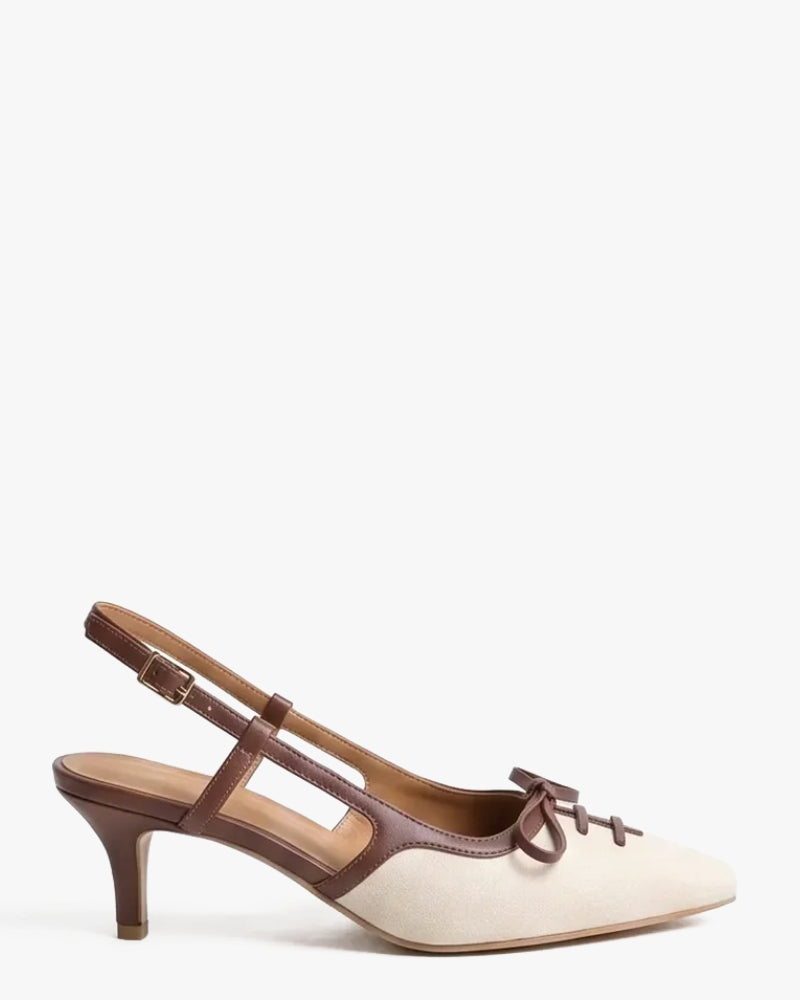 A single women's slingback kitten heel shoe with a cream-colored suede upper and dark brown leather straps, including a delicate matching bow on the toe box, shown against a plain white background.